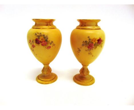 A PAIR OF ROYAL WORCESTER BLUSH IVORY PEDESTAL VASES shape 2260, painted floral decoration highlighted in gilt, 14.5cm high, 