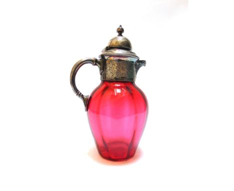 A LATE VICTORIAN CRANBERRY GLASS DECANTER with plated mounts and handle, 25cm high