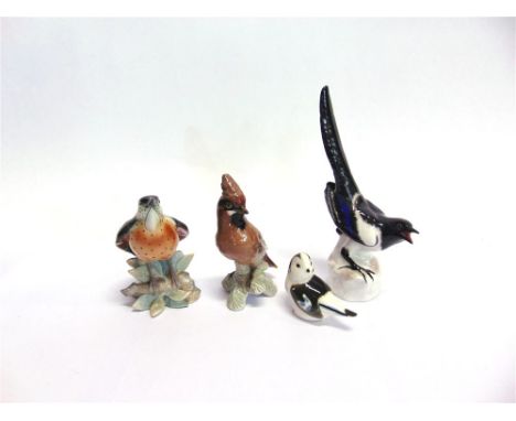 FOUR ASSORTED CERAMIC BIRD ORNAMENTS,  comprising two Lomonosov USSR birds the largest 25cm high, a Geobel bird and one other