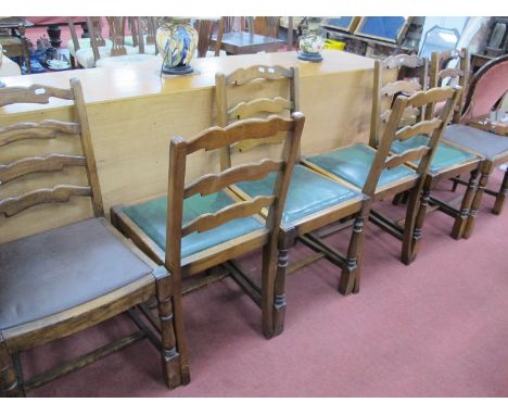 A Set of Six Oak Dining Chairs, each with wavy ladder backs, on turned and block supports.