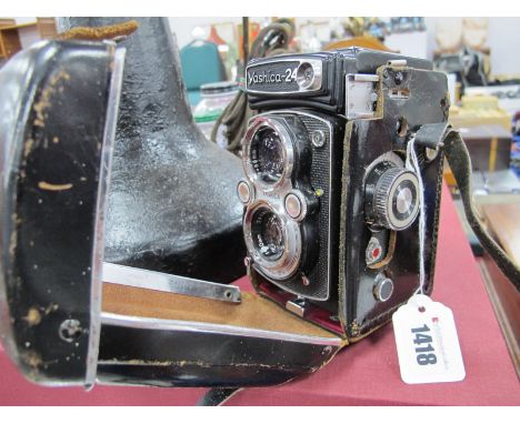 A Yashica - 24 Camera, featuring 1:2.8 &amp; 1:3.5 lenses.