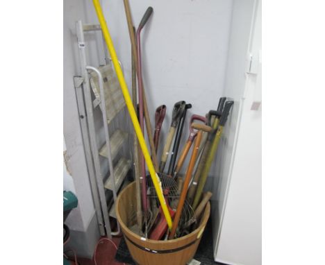 Garden Tools, rakes, fork, spade, a half round whisky barrel with black bands, step ladders.