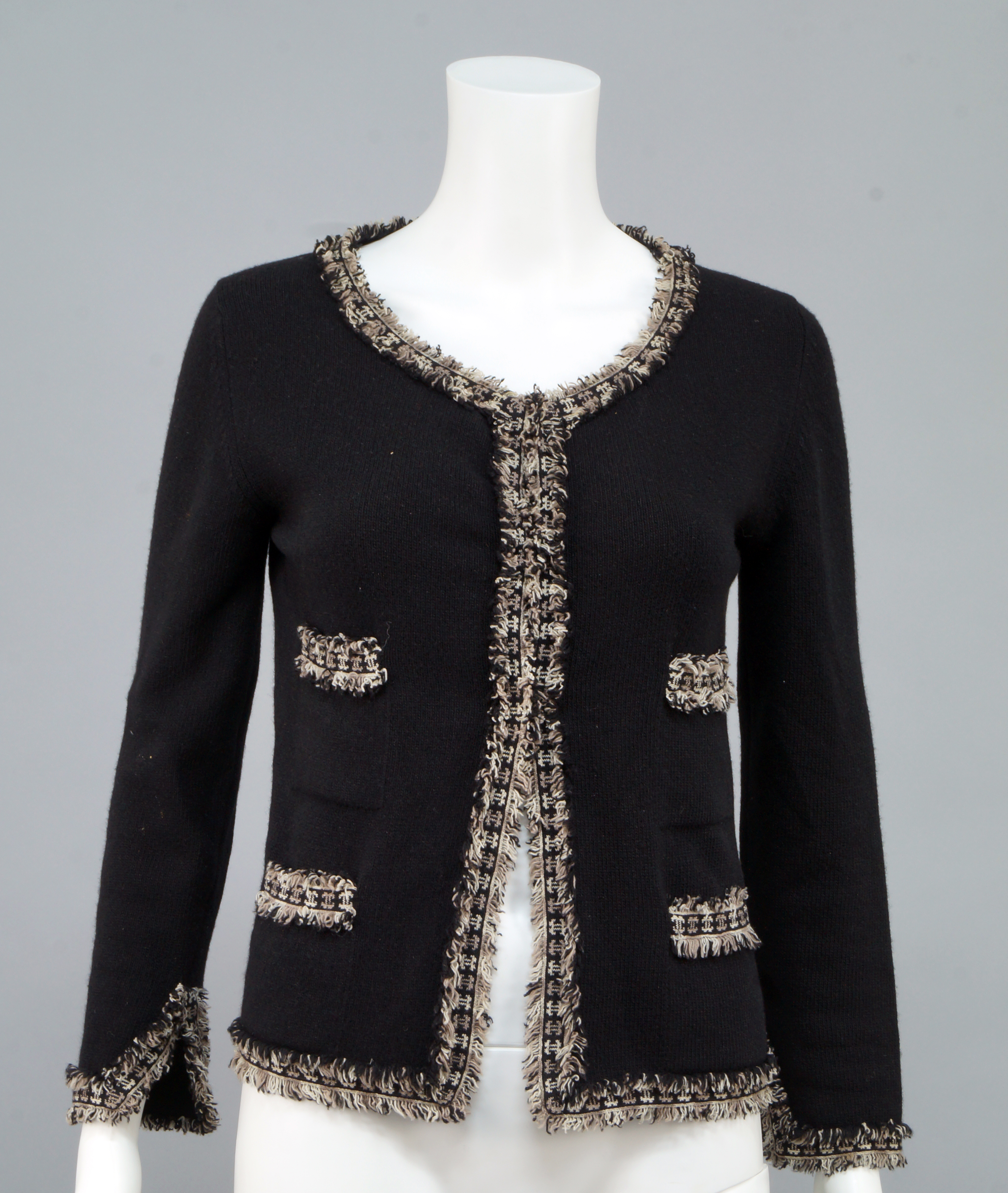 Chanel: a black cashmere twin-set, the cardigan and vest with frayed ...