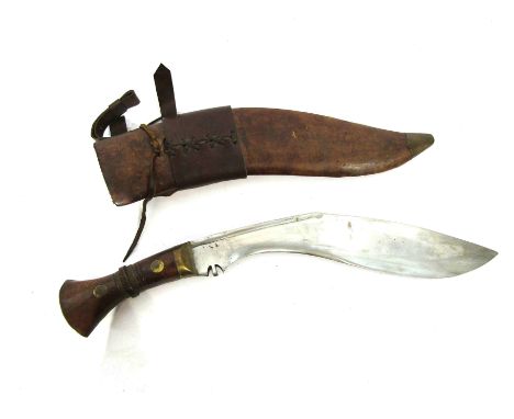 A kukri knife, the brass bound hardwood grip joining a curved blade bearing date 1917 with WD broad arrow, brown leather scab