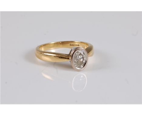 An 18ct diamond solitaire ring, the oval brilliant cut diamond, estimated approx. 0.52cts, in a white gold rubover mount, set