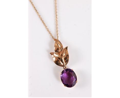 A 9ct amethyst pendant, the oval faceted amethyst, approx. 12.3 x 10 x 5.4mm, in a four claw mount and surmounted by three ta