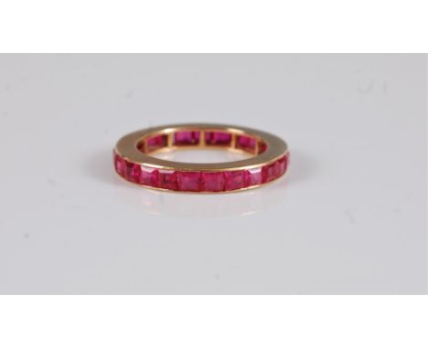 A synthetic pink sapphire eternity ring, the full hoop eternity ring channel set with square cut synthetic pink sapphires, al