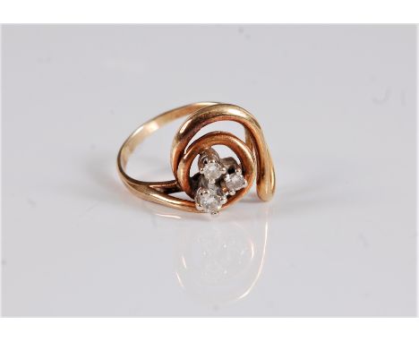 A three stone diamond ring, the three round brilliant cut diamond, estimated approx. 0.18cts, claw mounted to a tapered swirl