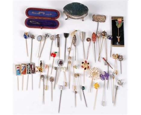 A group of assorted stick pins: to include silver, enamel, gilt metal, contemporary novelty stick pins, and a silver pin cush