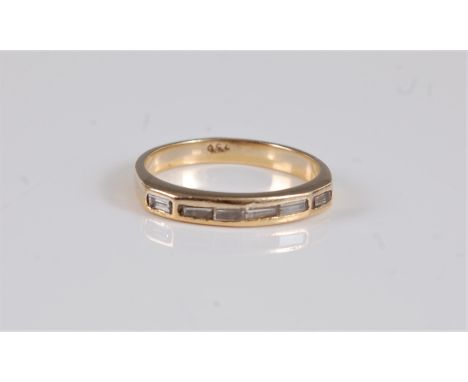 An 18ct diamond half hoop ring, with channel set baguette cut diamonds, total estimated approx. 0.48cts, with plain band stam