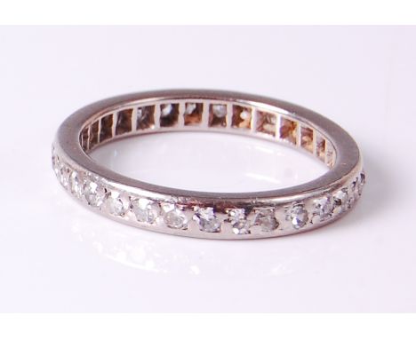 A white metal diamond eternity ring, arranged as pavé set old cut diamonds, total diamond weight estimated at approx 1ct, 3.5