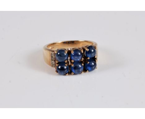 A 9ct sapphire and diamond ring, the six round sapphire cabochons, each claw set, with two small round diamonds to either sid