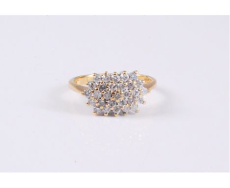 An 18ct diamond cluster ring, the diamond cluster comprised of small round brilliant cut diamonds, total estimated approx. 0.