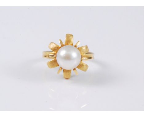A continental cultured pearl dress ring, the drilled cultured pearl, rotating within a six claw mount and six further outswep