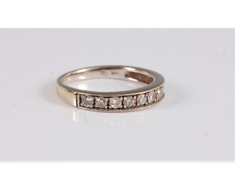 A 14k diamond half hoop eternity ring, the round brilliant cut diamonds, total estimated approx. 0.44cts, channel set with mi