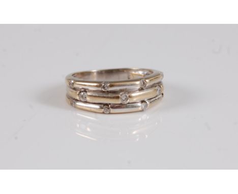 An 18k diamond half hoop ring, the three ridged bands set with small round diamonds, total estimated approx. 0.22cts, taper t