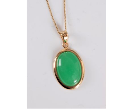 A 14k jade pendant, the oval jade cabochon pendant, 17mm long, collet mounted with hanging loop stamped 14k, on fine 9ct chai