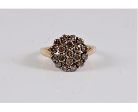A 9ct diamond cluster ring, the chocolate coloured round brilliant cut diamonds, total estimated approx. 1.26cts, with tapere