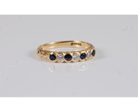 An 18ct sapphire and diamond ring, the alternating round sapphires and brilliant cut diamonds, total weight of diamonds estim
