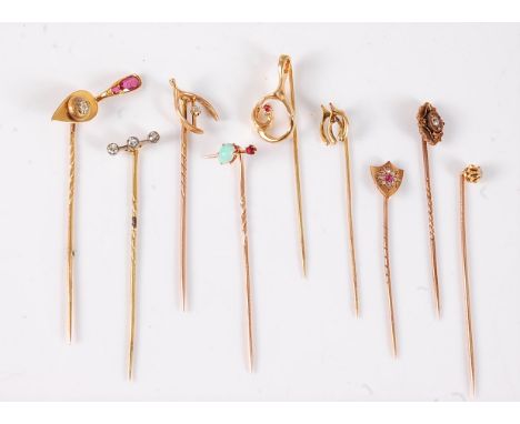 Nine variously gemset stick pins: a ruby and diamond set trowel stick pin, 22mm wide; a three stone old cut diamond stick pin