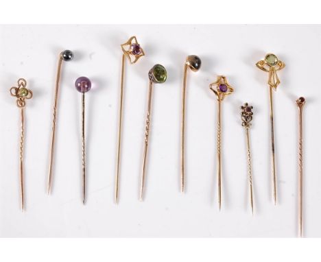Ten gemset stick pins: a moss agate stick pin stamped '14'; an Art Nouveau style stick peridot stick pin stamped '14': two 9c
