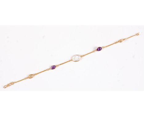 A 14k moonstone, amethyst and citrine bracelet, the central oval moonstone cabochon, set to either side with a faceted amethy