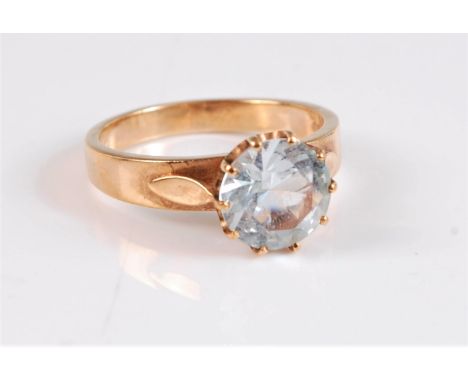 A 9ct topaz ring, the pale blue topaz approx. 8.3mm diameter, claw mounted with leaf shaped shoulder detail and plain band st
