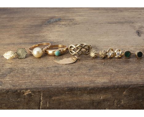 A small collection of gold and yellow metal, including three dress rings, one of knot design, ring size L, another set with c