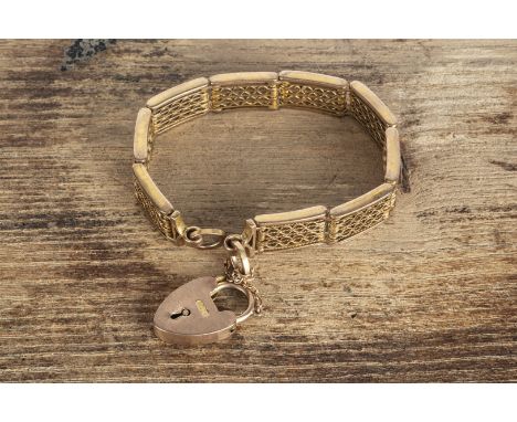 A yellow metal 9c marked Art Deco gate link bracelet, with padlock clasp, 17.5cm x 1.2cm, 24g 