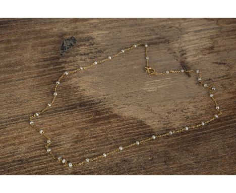 An Edwardian 15ct gold seed pearl fine chain, 21.5cm together, marked 15ct to clasp, 1.6g 