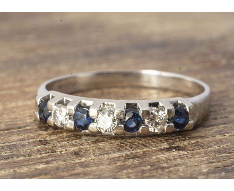 A white gold sapphire and diamond seven stone dress ring, in claw settings, plain shank, ring size R, diamond weight 0.15ct a