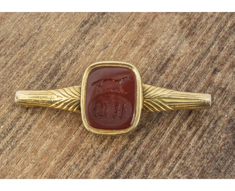 A converted cornelian signet ring, now a brooch, with engraved intaglio of a greyhound and gothic initials RB having a tapere