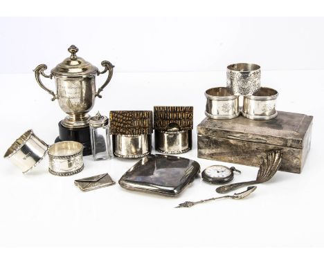 A small collection of silver, including seven napkin rings, two pairs, a Georgian tea caddy spoon, a small covered silver tro