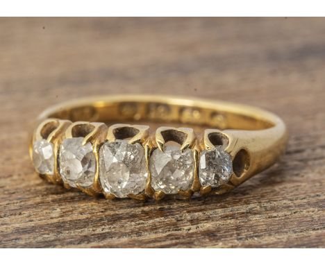 An 18ct gold five stone old cut diamond ring, the cushion cuts in claw setting, ring size K, 0.65ct approximately, 3.4g 