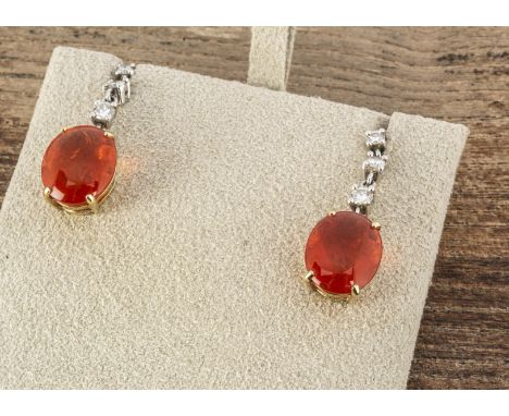 A pair of fire opal and diamond drop earrings, the oval cabochon claw set opals approximately 2ct each, supported on graduate