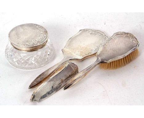 Hallmarked silver three piece mounted dressing table wares including hand mirror, hairbush and glass powder bowl and cover, h