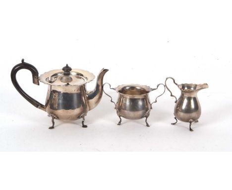 Three pieces of hallmarked silver tea ware to include an Edwardian teapot of baluster form, hinged lid with ebonised finial a