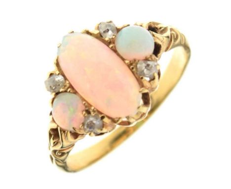 Three stone opal ring, stamped '18ct', the long central cabochon flanked either side by small round cabochons, with old cut d