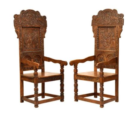 Pair of late 19th Century oak Wainscot chairs, of 17th Century style, both with solid backs with inset figural carved panels 