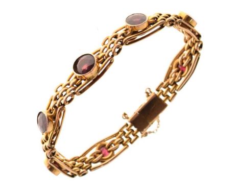 Garnet set bracelet, stamped ‘9c’, with seven round cuts to a gate link style bracelet, 19g gross, casedCondition report: Gen