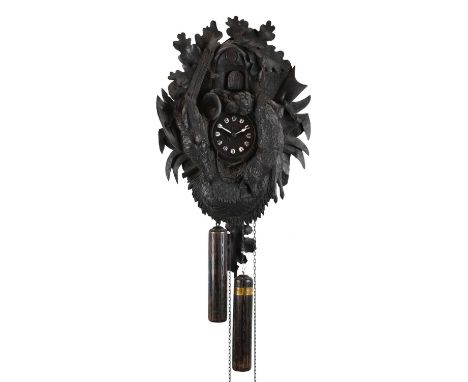 Black Forest carved cuckoo clock, circa 1900, 3.25-inch cellular Roman dial, two-train movement with bellows-operated cuckoo,