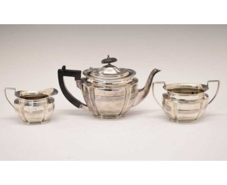 Edward VII silver three piece tea set of oval form with ribbed decoration comprising teapot, twin handle sugar bowl and cream