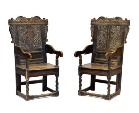 Pair of 17th Century oak Wainscot chairs, the shaped cresting rails centred with winged cherub mask flanked by punchwork enha