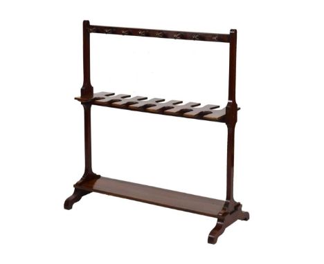 Mahogany boot and whip rack, circa 1900, with sixteen whip or crop pegs over seven pairs of boot recesses, on platform base, 