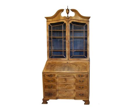 Early 20th Century Continental walnut and mahogany bureau bookcase, the upper section with urn finial and swan-neck pediment 