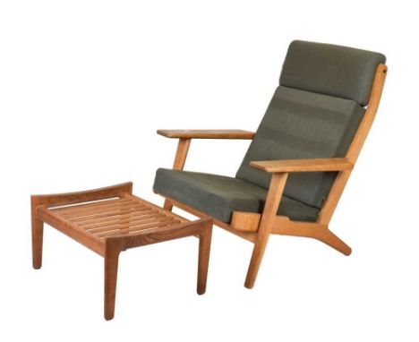 Hans Wegner for Getama, oak framed armchair and ottoman, designed circa 1955, slatted wooden back, sprung seat, with original