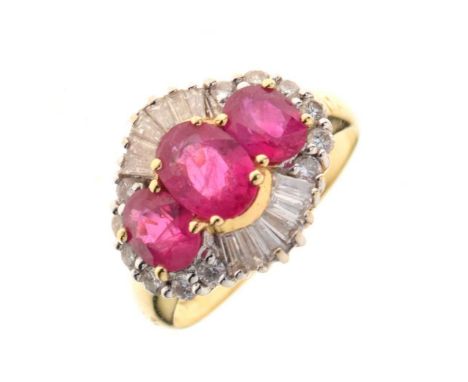 Ruby and diamond ballerina cluster ring, stamped '750', the three graduated oval cuts enclosed by six tapering baguettes abov