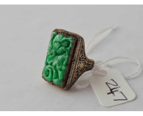 A carved jade panel ring the white metal shank reading silver and china 