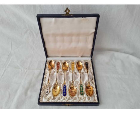 A set of six Danish sterling silver gilt and enamel coffee spoons 