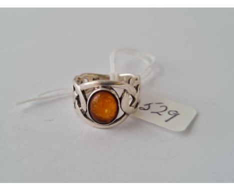 A Celtic style silver and amber ring 